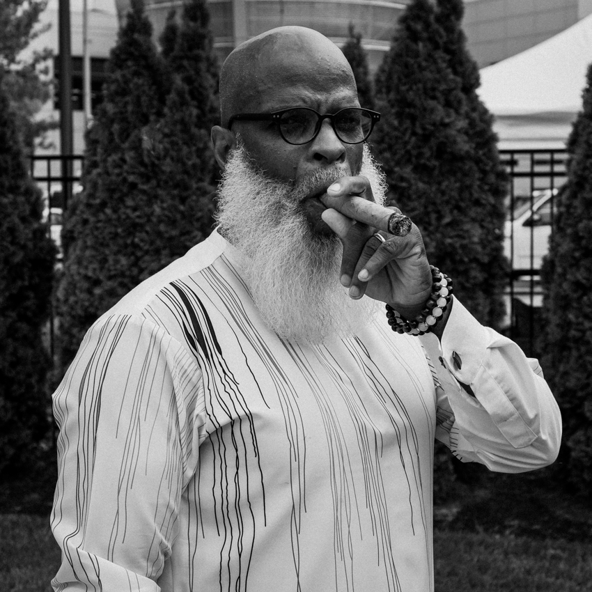 A black gentleman smoking a cigar