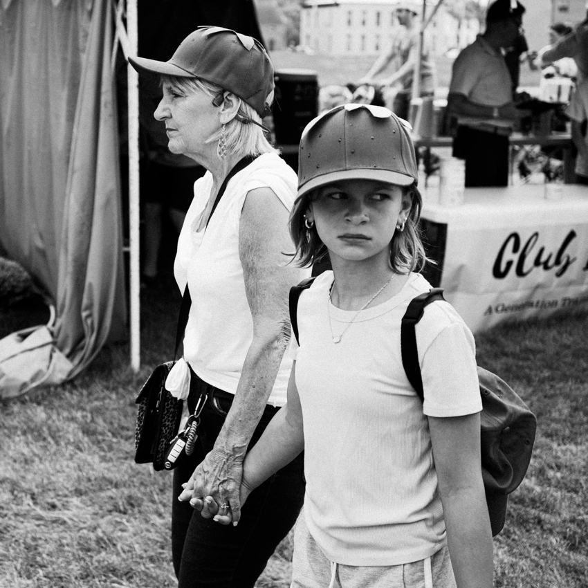 Grandmother and granddaughter wearing strawberry hats