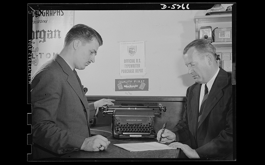 John K. Stockham, Washington, D.C. insurance man, turns a machine over to Don MacDonald, Washington, D.C. typewriter dealer